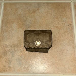 Never used. Brown / tan Coach earbud case.